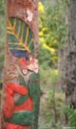 Half Man-made (Pole with Aboriginal Art) and Half Nature (Wattle tree and flowers) (Also Half Focussed and Half Blurry)