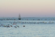Paddlers and support boats waiting for their swimmers with Rottnest Island in the background